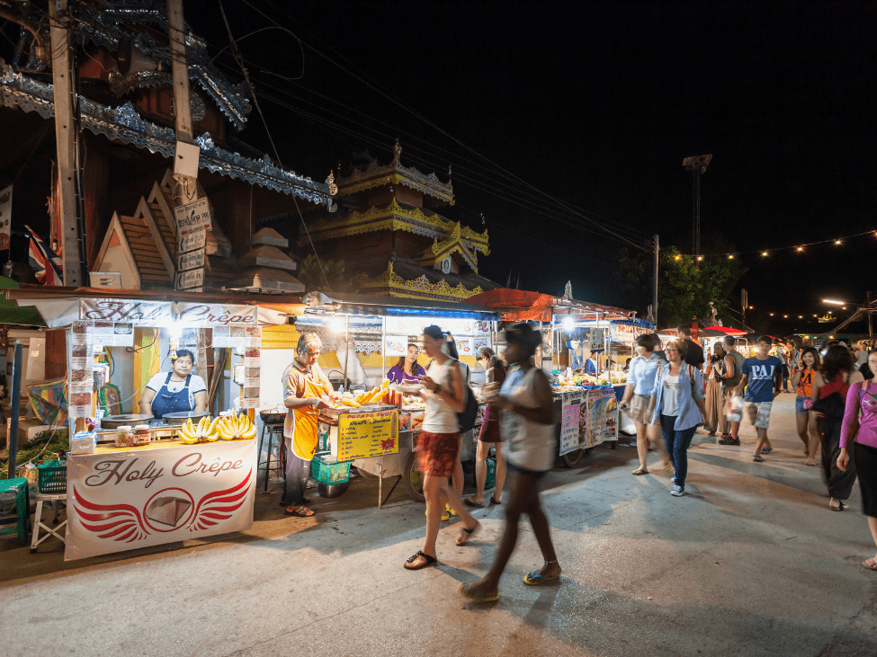 Bustling Chiang Mai Night Bazaar filled with vendors, street food, and local crafts