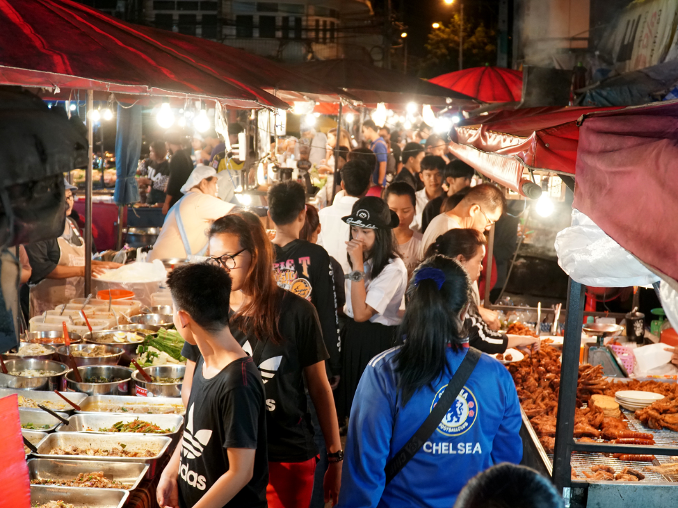 Tourists enjoying Chiang Mai’s bustling street markets at night. 