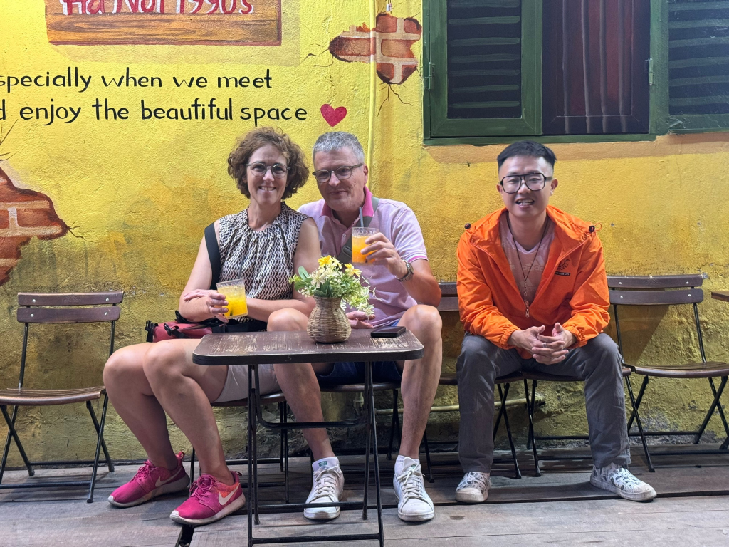 Quiet residential alley in Hanoi with local cafes and small shops.