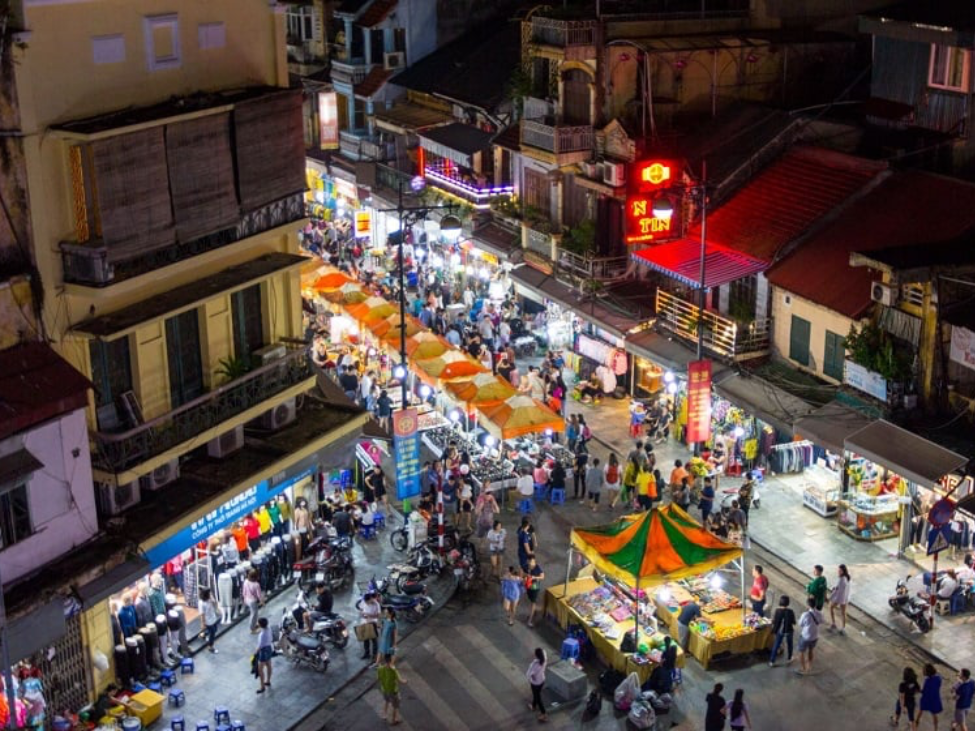 Vibrant Hanoi Old Quarter Night Market with street food and souvenirs.