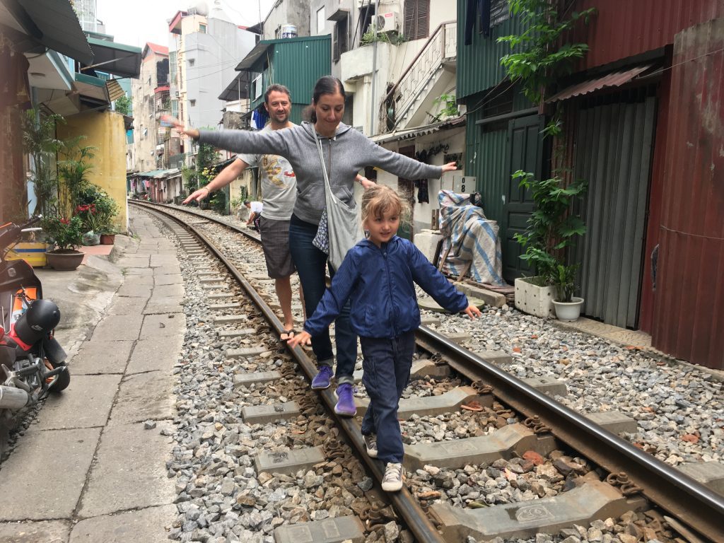 Visitors enjoying a safe experience near the train tracks in Hanoi.