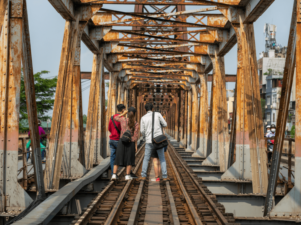 Pedestrians and cyclists enjoying a stroll on Long Bien Bridge’s walkway.