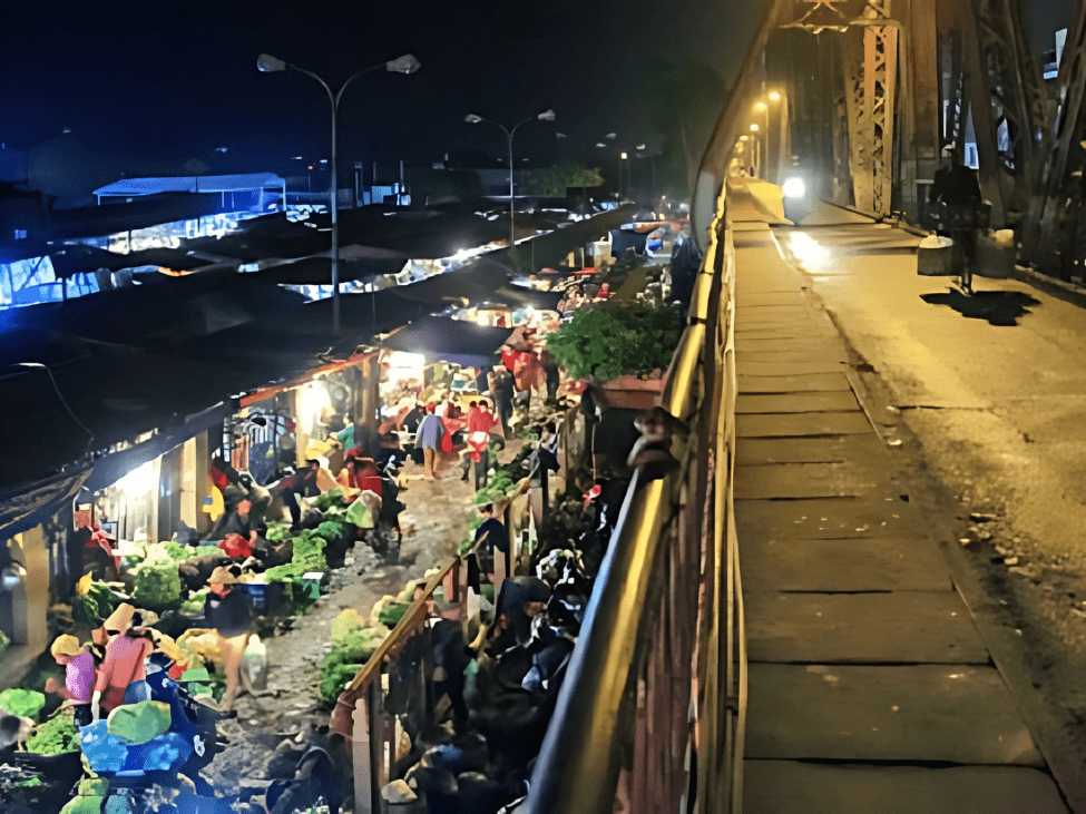 Bustling morning scene at Long Bien Market with vendors and fresh produce.