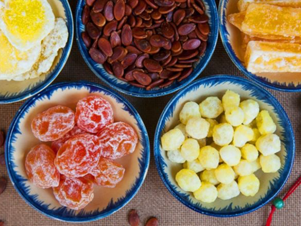 Tet sweet treats platter featuring candied fruits and seeds.