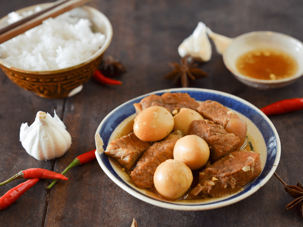 A bowl of braised pork and eggs in caramelized sauce.