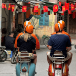 Vespa rider exploring Hanoi’s Old Quarter at sunrise.