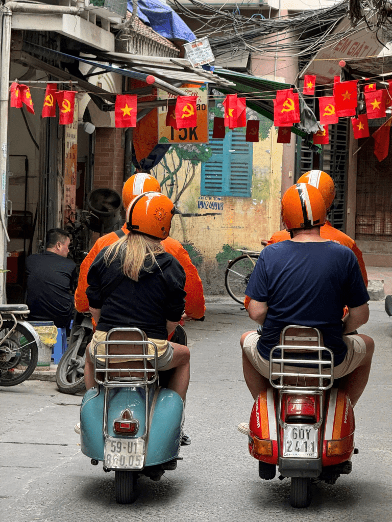 Vespa rider exploring Hanoi’s Old Quarter at sunrise.