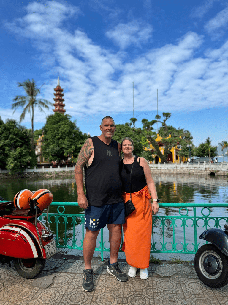 Vespa group touring along Thanh Nien Street at sunset