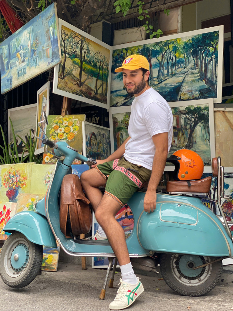 Colorful street mural depicting traditional Hanoi scenes along Phung Hung Street.