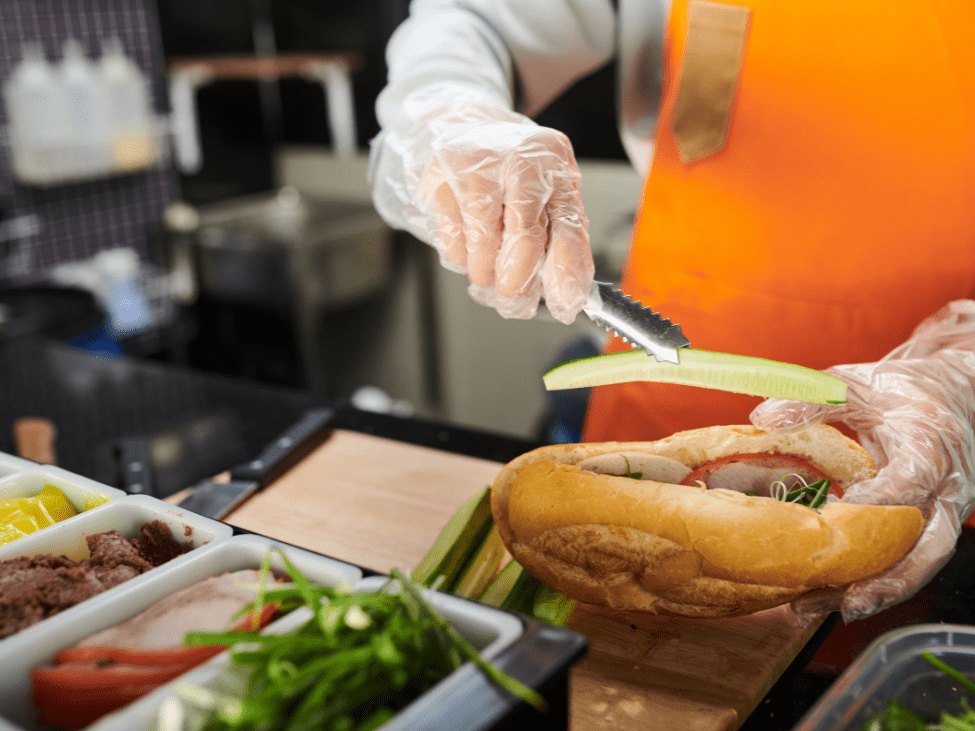 A Vietnamese banh mi sandwich filled with grilled pork, fresh herbs, and pickled vegetables.